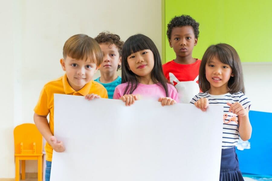Diversity children holding blank poster in classroom at kindergarten Diversity Equity and Inclusion in STEM